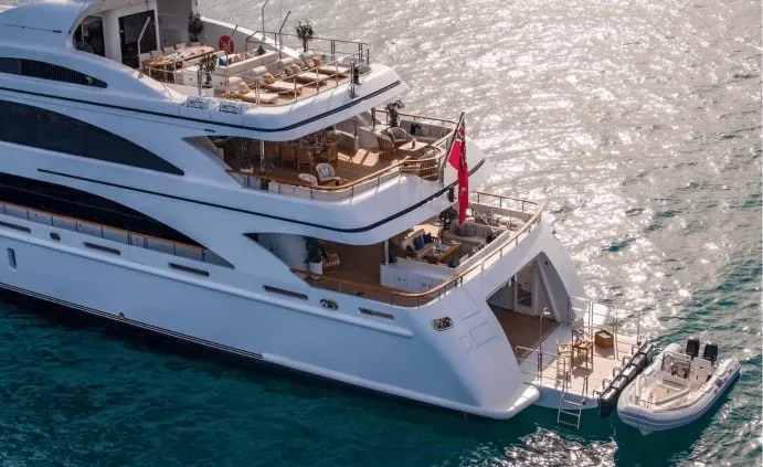 Aft deck of a luxury charter yacht with tender alongside