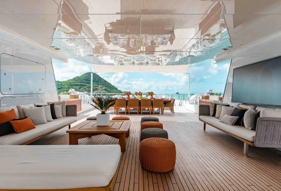 Shaded deck lounge on a superyacht looking out to a bay